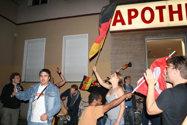 Jubelnde Fußballfans in Berlin mit türkischer und deutscher Fahne